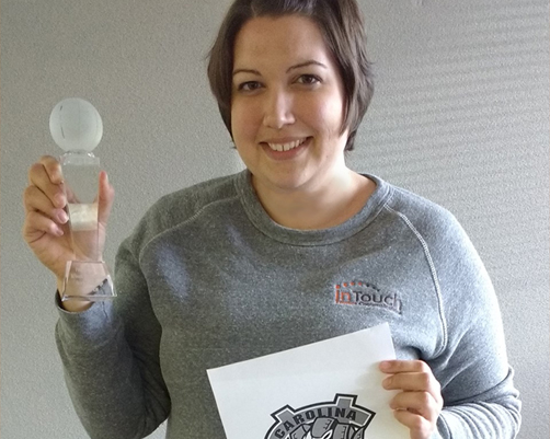 Lisa holding trophy from winning the 1st annual Intouch NCAA March Madness bracket