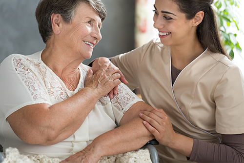 elderly woman being assisted by nurse